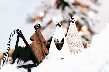 Boho Christmas tree ornaments showing wood, black, and white shapes with striped rope hangers