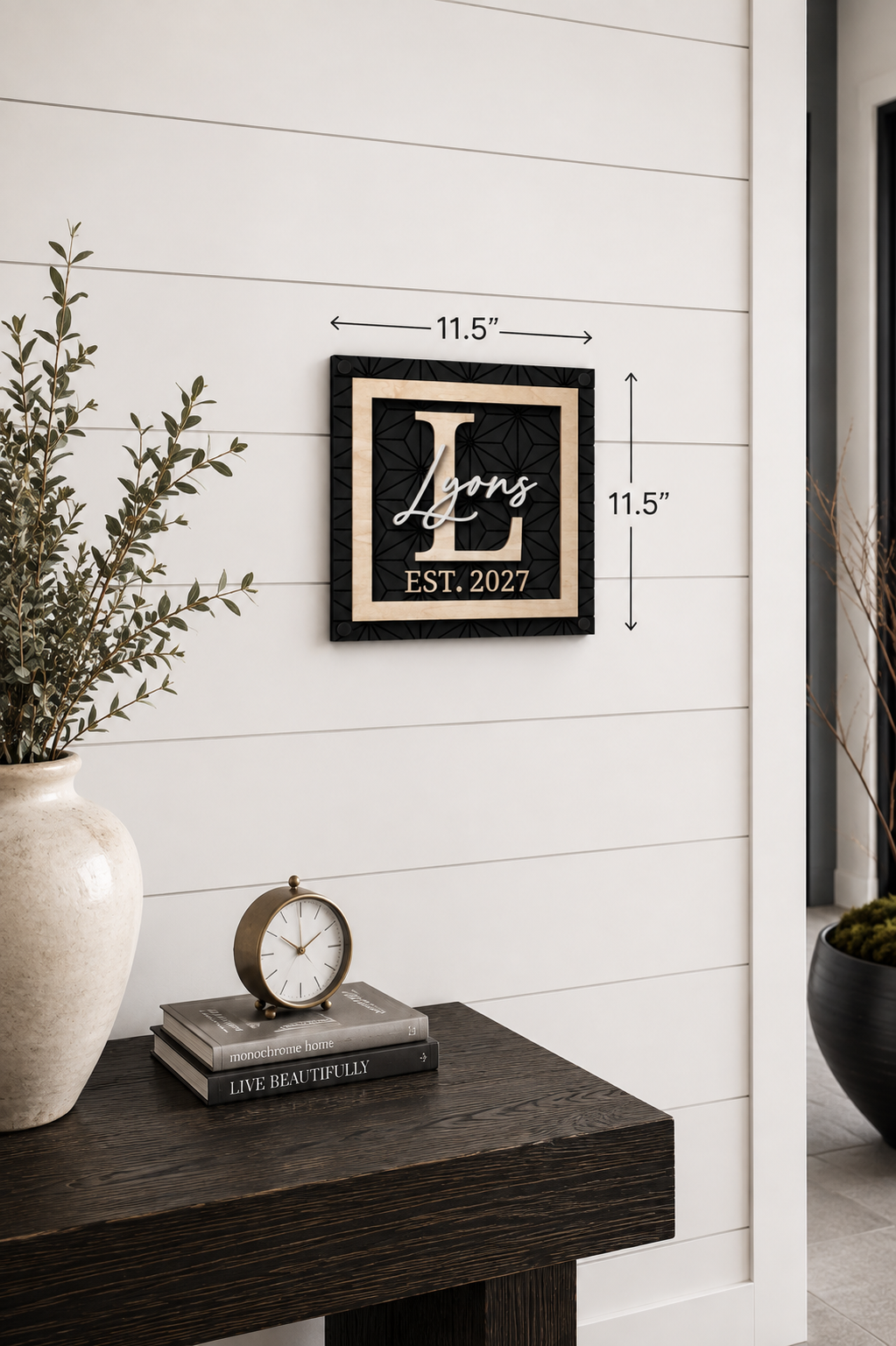 Framed monogram family name sign, black with gold script, EST. 2027; 11.5 in.