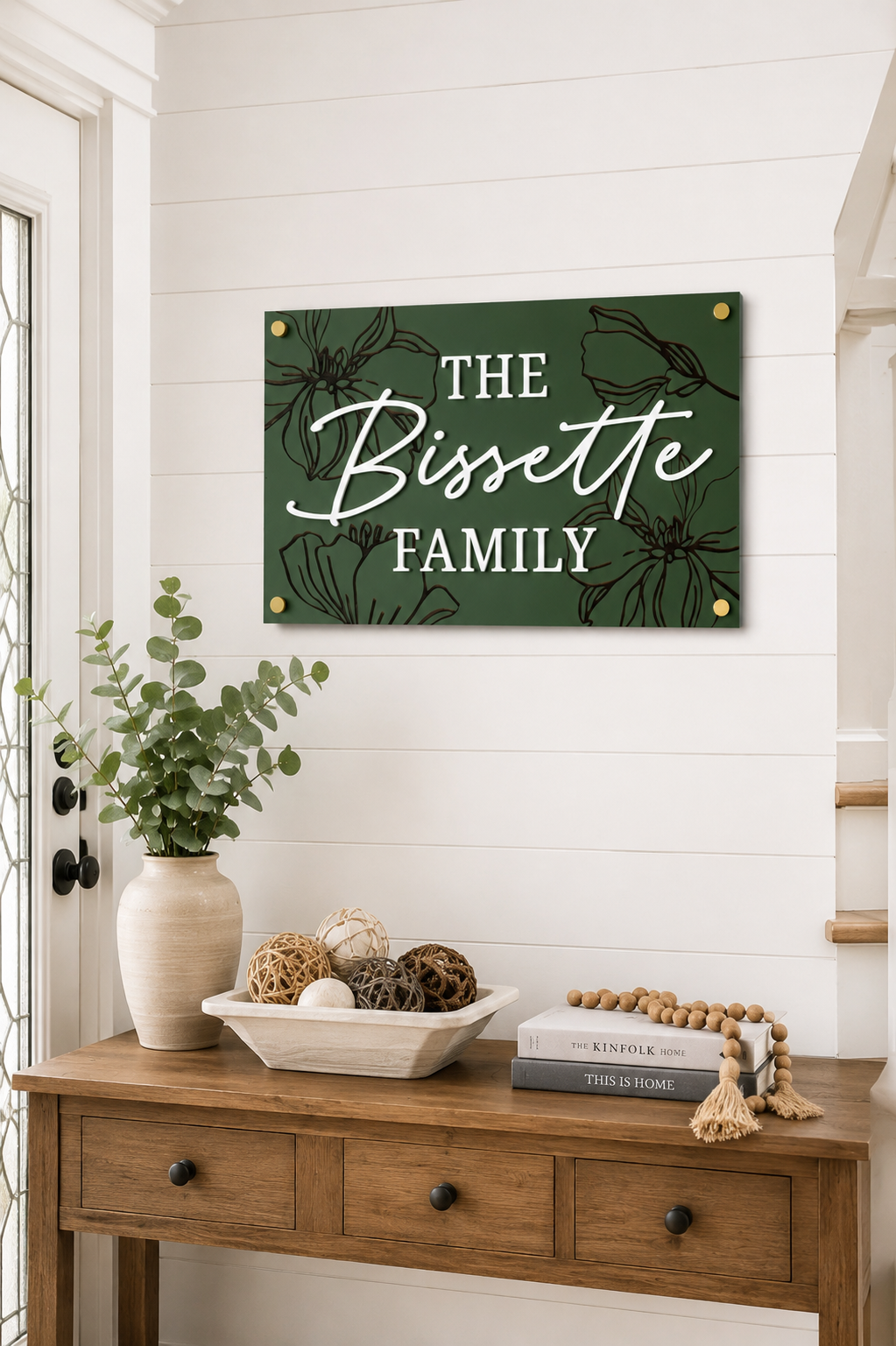 Dark green rectangular family name sign with bird and floral engraving: THE Bissette FAMILY