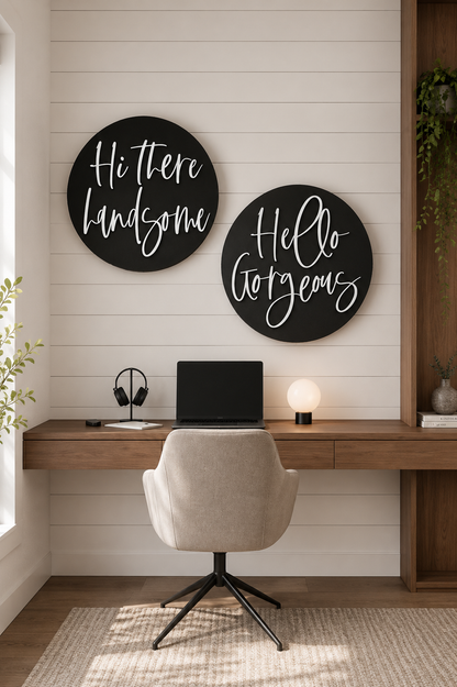 Two round black wall signs with white cursive wording: “Hi there handsome” and “Hello gorgeous”.