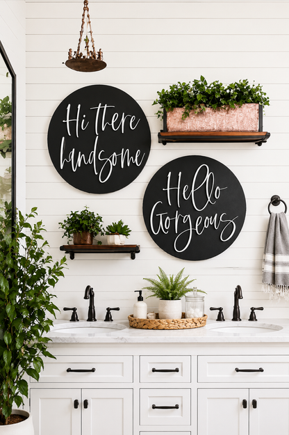 Two round black wall signs with white cursive: “Hi there handsome” and “Hello gorgeous” above sink.