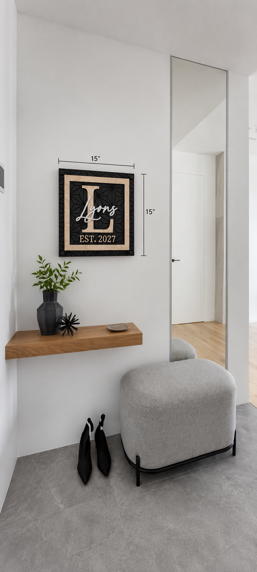 Wall-mounted framed monogram family name sign, black background, gold script, EST. 2027.