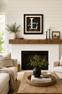 Framed black monogram family name sign with gold script and EST. 2027 on fireplace wall.