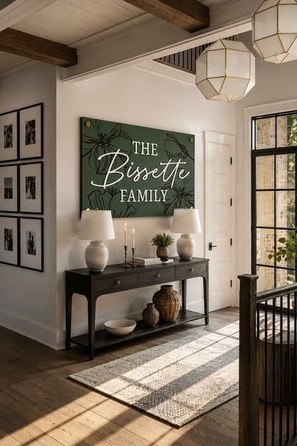 Dark green rectangular family name sign with bird and floral engraving: THE Bissette
