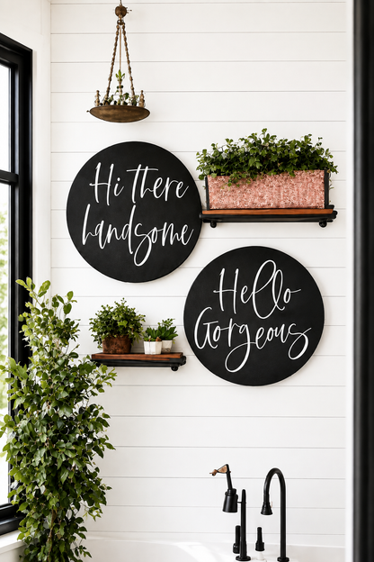 Two round black wall signs with white cursive text: “Hi there handsome” and “Hello gorgeous”.