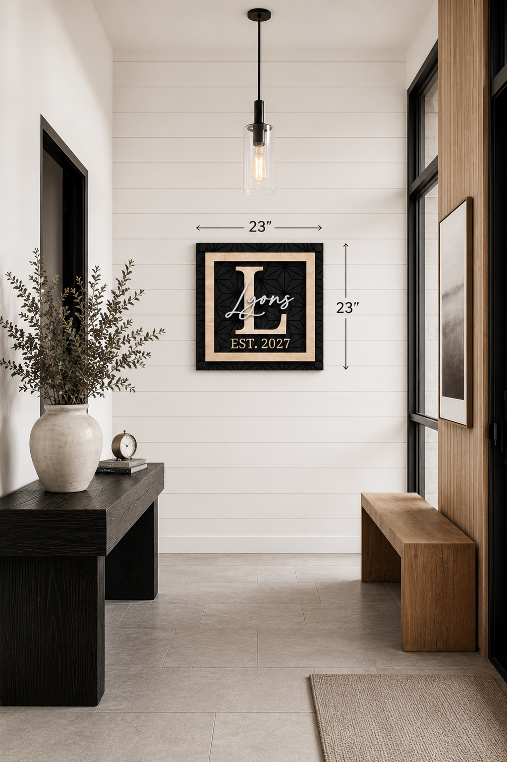 Framed monogram family name sign, black with gold script, EST. 2027; 23 in wall display.