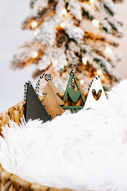Natural wood Christmas tree ornaments with green and dark pieces, striped string hangers