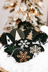 Black wooden ornament discs with snowflakes and a tan Christmas tree, hanging loops