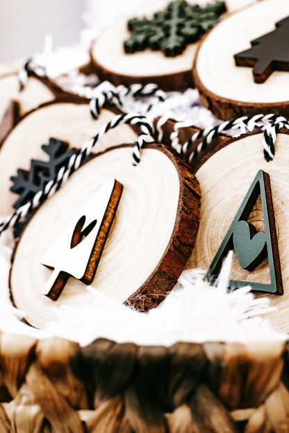 Rustic wood slice ornament set with pine tree and number charms, on black-and-white string