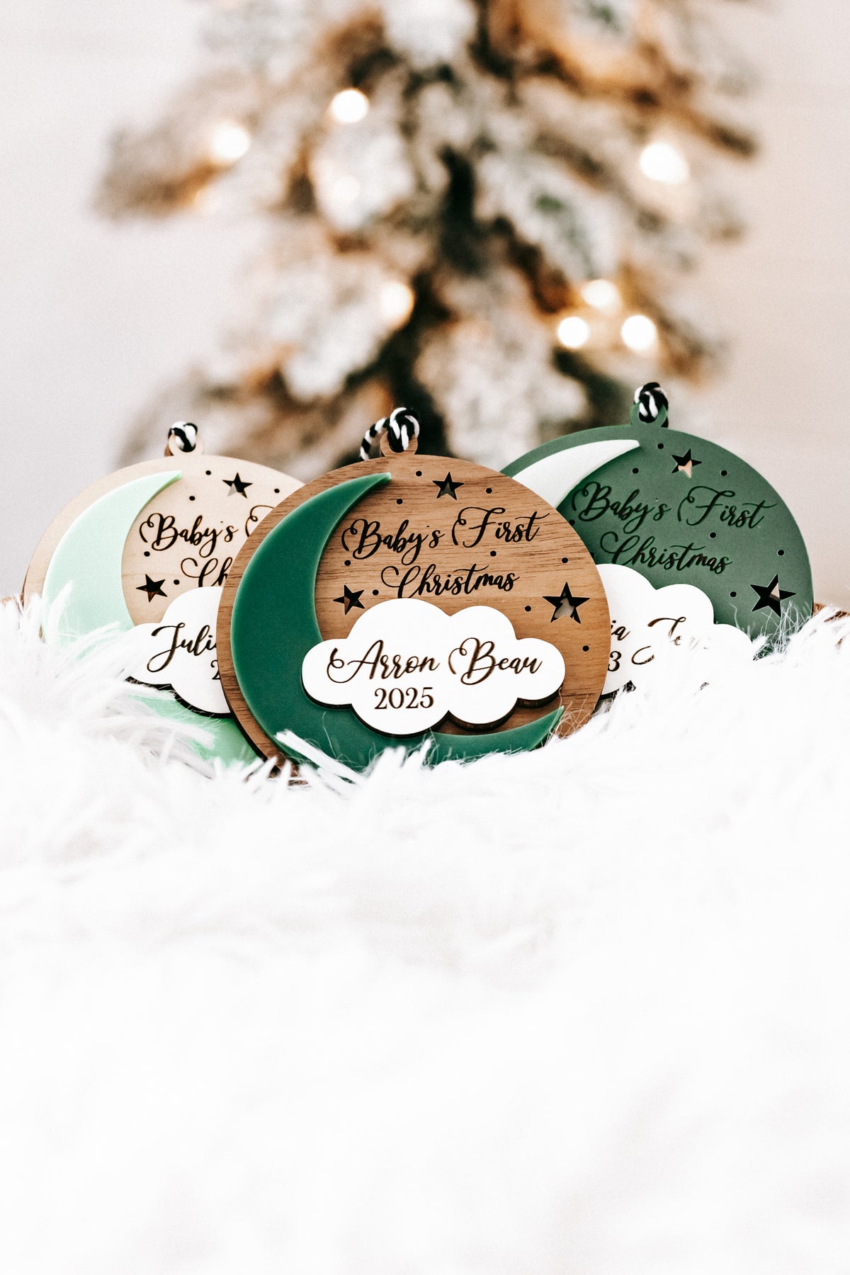 Dark green round ornament with hanging loop and white cloud tag: Aaron Bear, 2025.