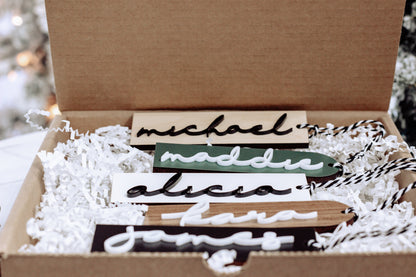 Personalized stocking name tags with wood and paper letters in a gift box