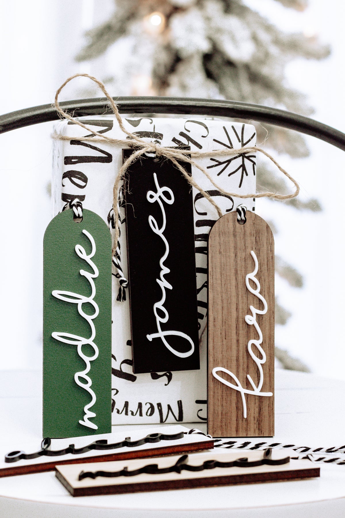 Hanging modern stocking tags in green, black, and brown with white script