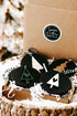 Set of black Christmas ornaments with tree shapes in a straw basket, Lumber & Letters sticker