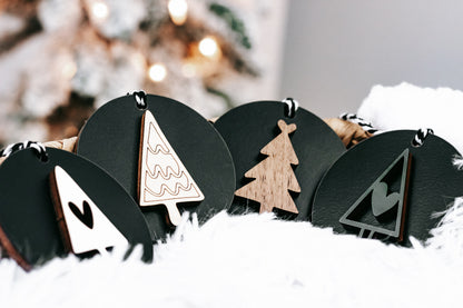 Set of black Christmas ornament discs with tree designs and hanging loops