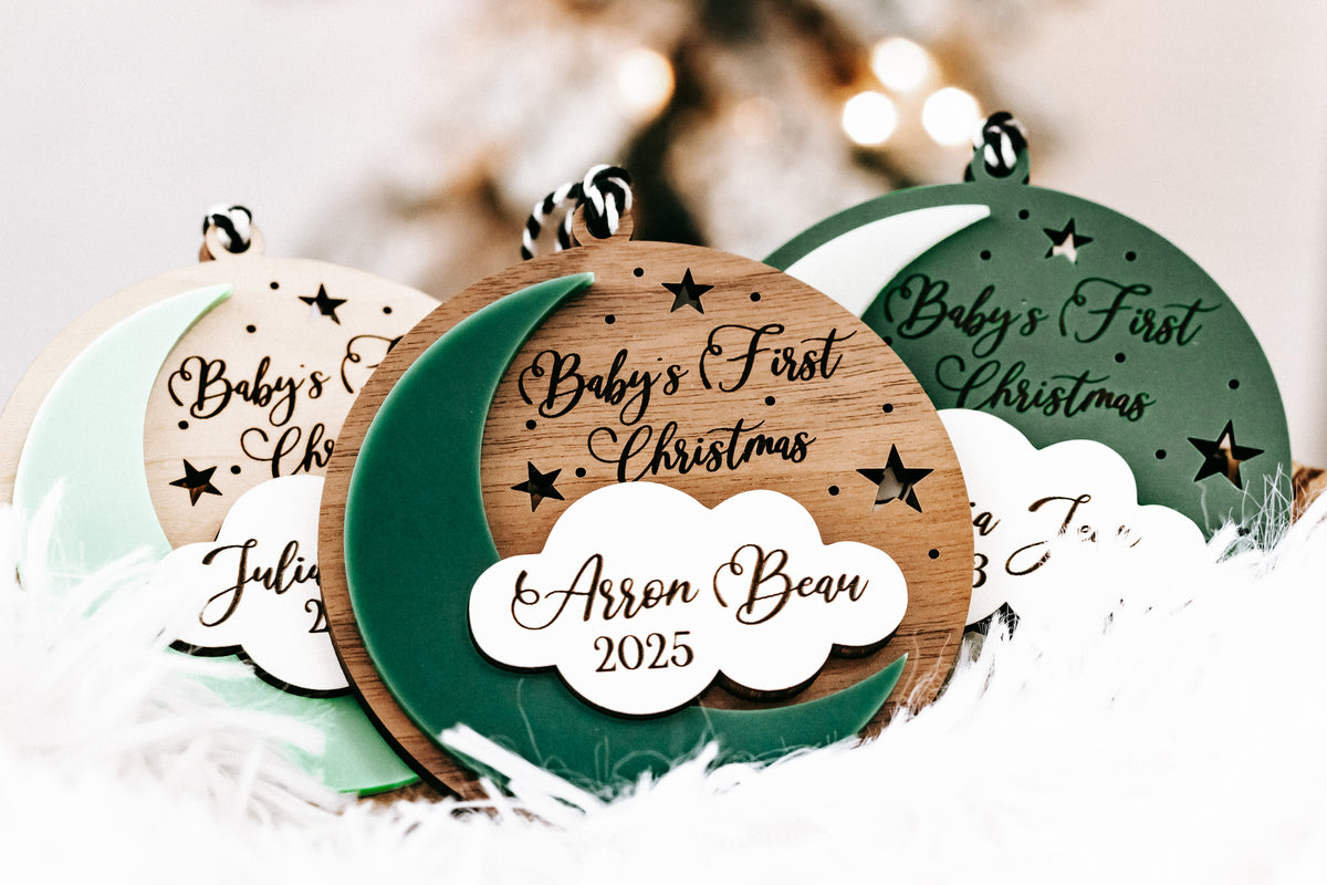 Hanging round ornaments in tan and dark green with white cloud name tags and years.
