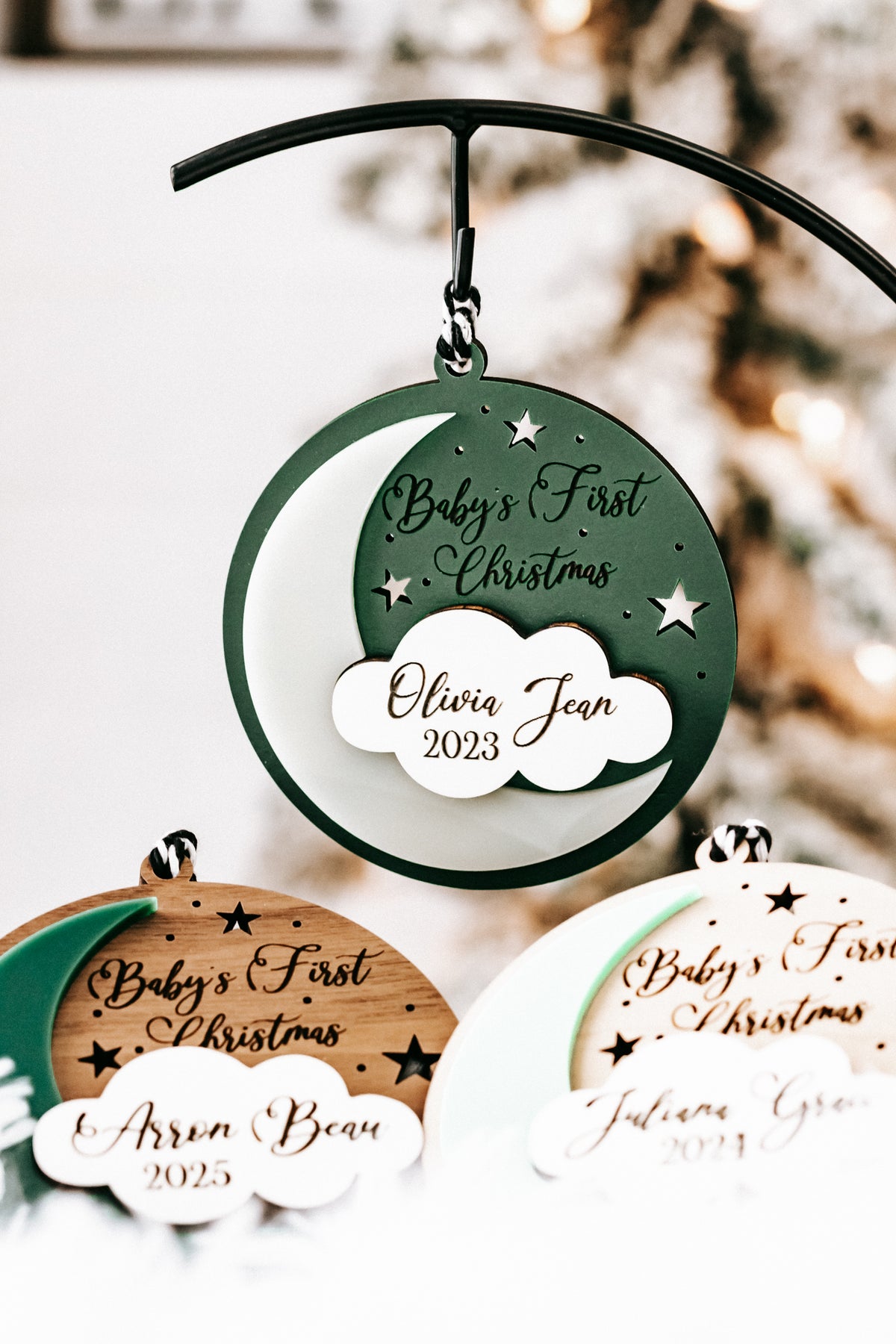 Green hanging round ornament with hanging loop and cloud tag: Olivia Jean, 2023.