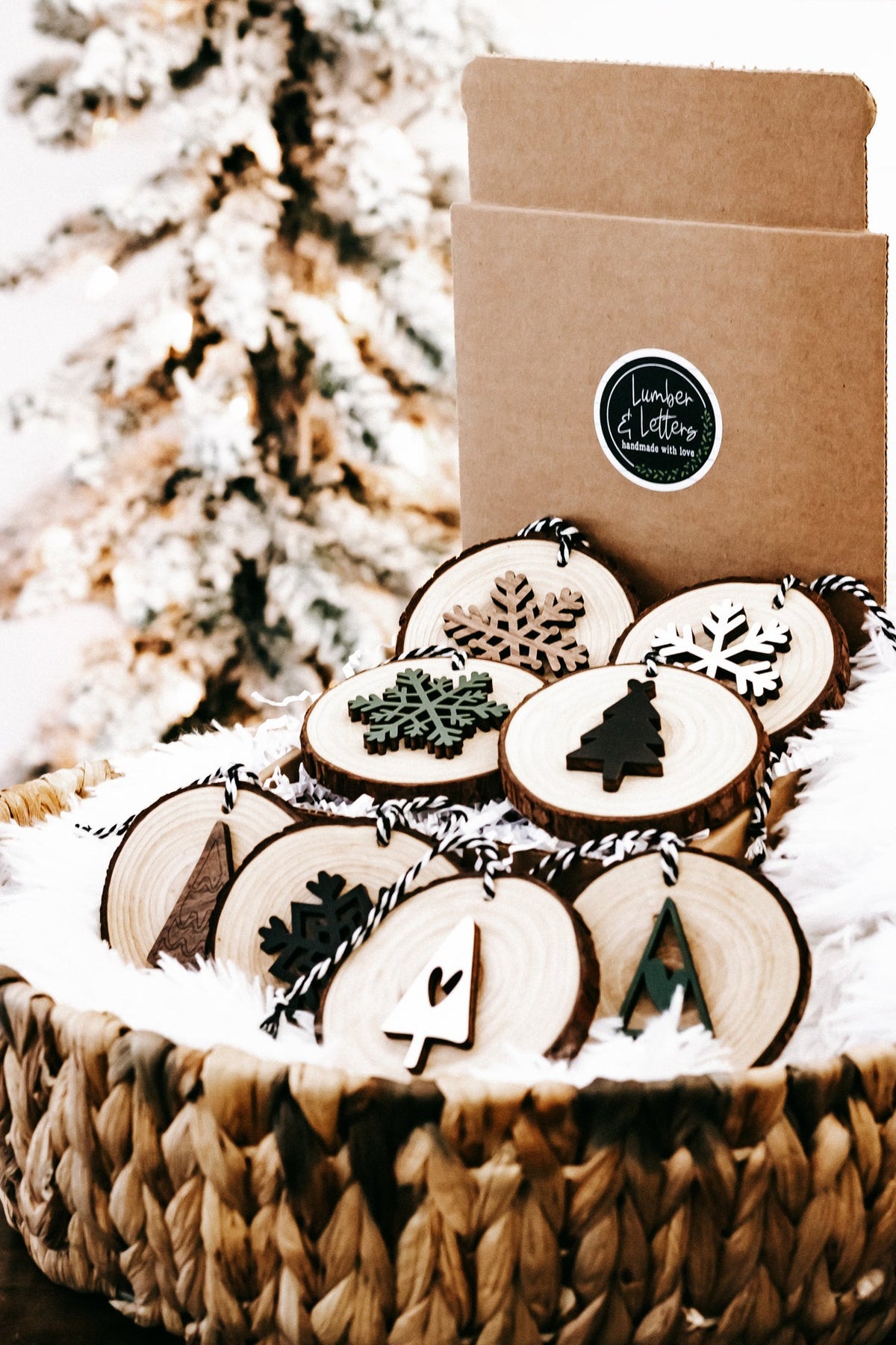 Rustic wood slice ornament set in kraft box with snowflake and tree designs, on strings