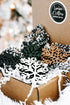 Close-up of mixed-color snowflake Christmas tree ornaments with black-and-white string loops