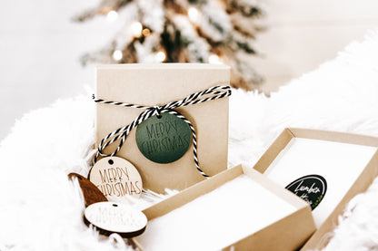 Customized snowflake ornaments in open gift box with kraft inserts and “MERRY CHRISTMAS”