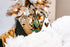 Natural wood Christmas tree ornaments with green and dark details, striped string hangers