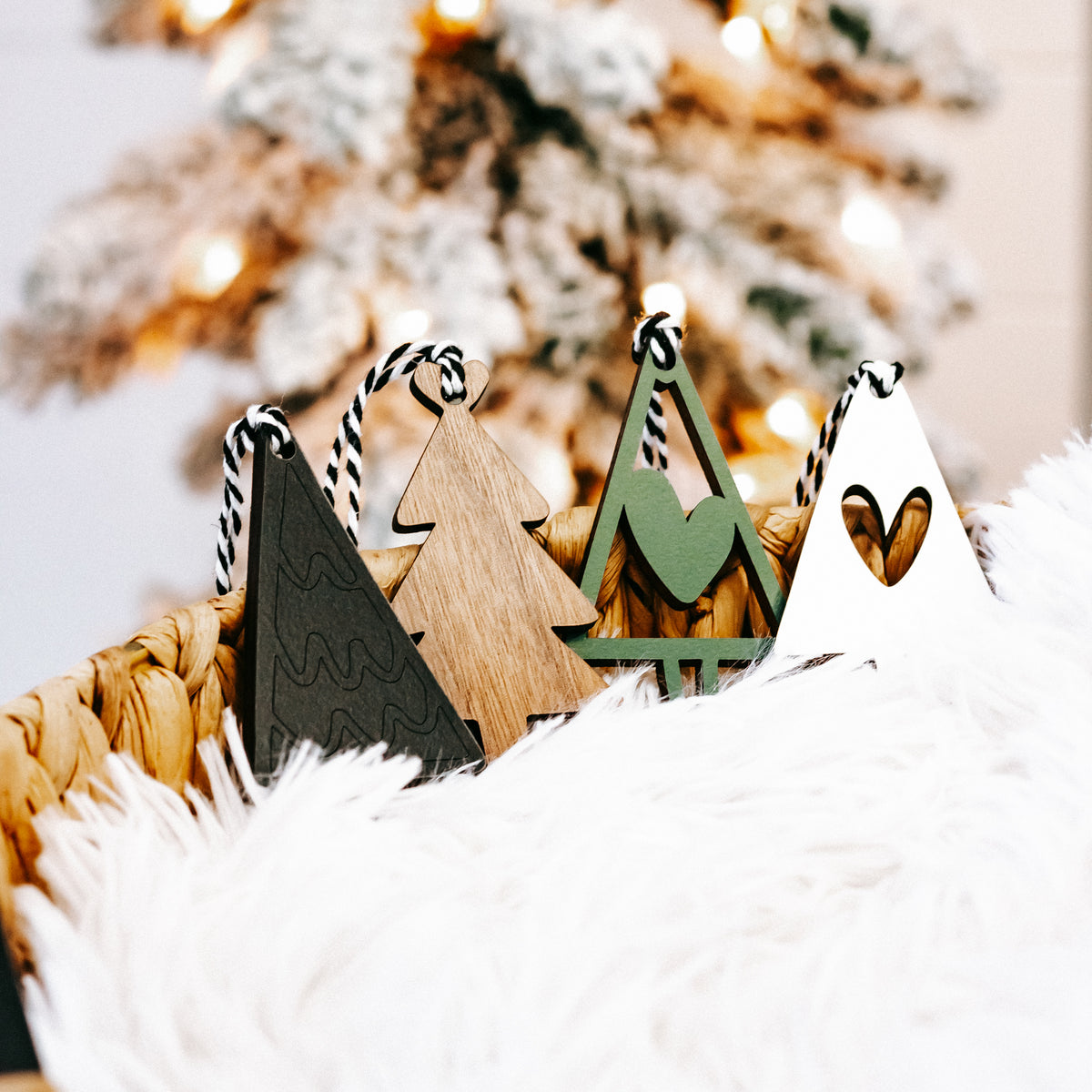 Natural wood Christmas tree ornaments with green accents and striped string hangers