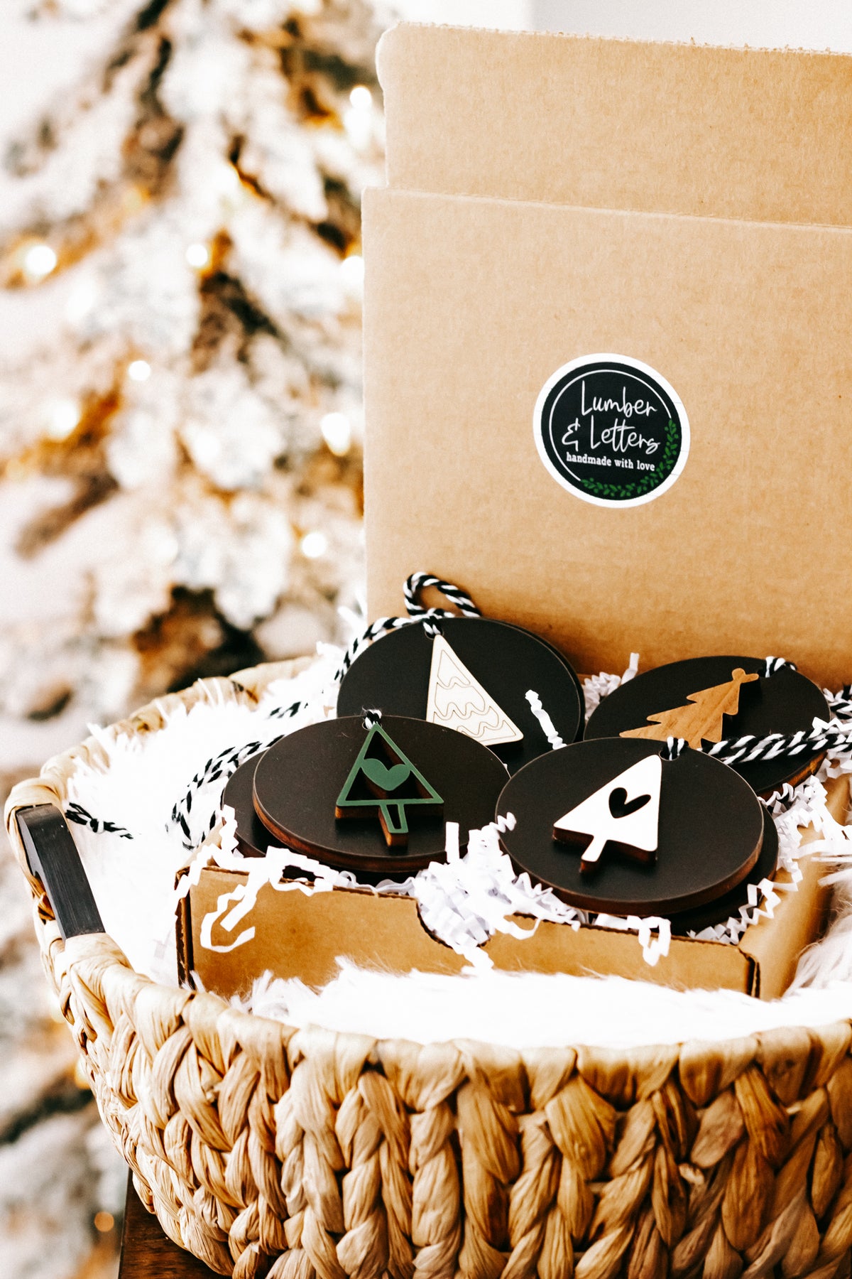 Black Christmas ornament set with tree designs and pine silhouettes, twine strings, by kraft box