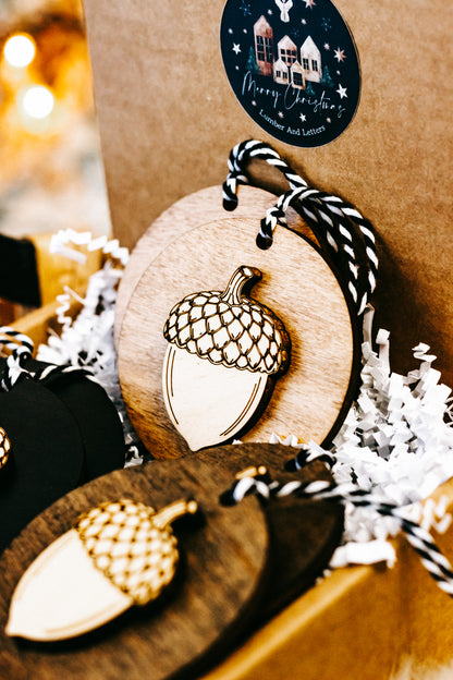 Round acorn ornament detail: wood disc acorn with gold checkered cap, striped twine loop.