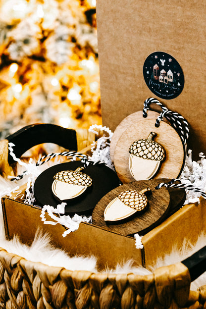 Round acorn Christmas ornament with night house design and woven rope loop hanger