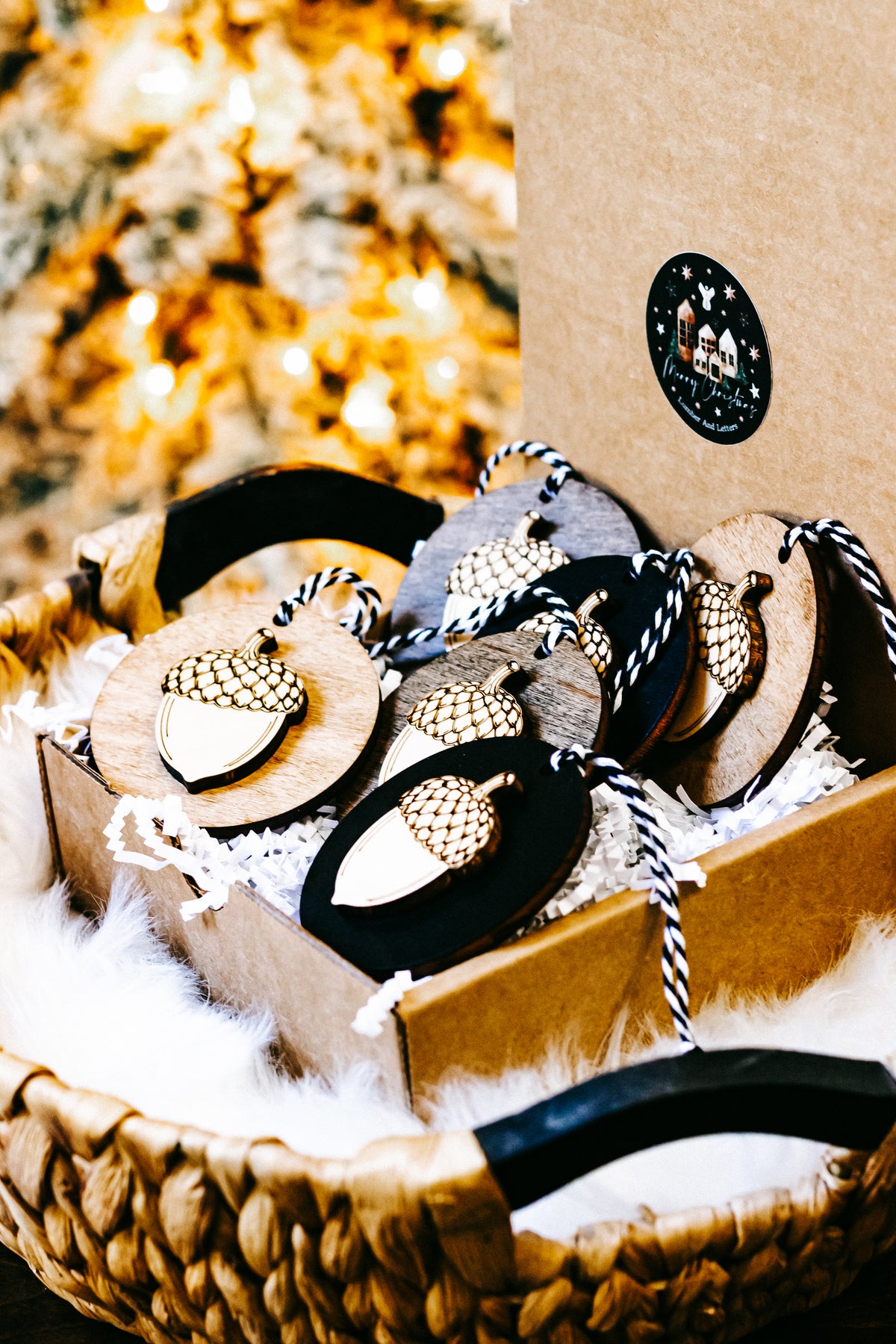 Tray of round acorn ornaments with gold checkered caps on black and wood bases, twine loops.