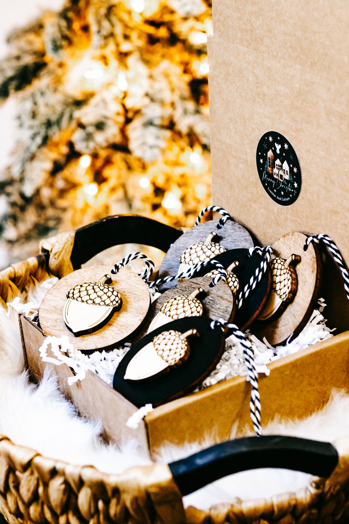 Tray display of round acorn ornaments with gold checkered top caps and twine loops.