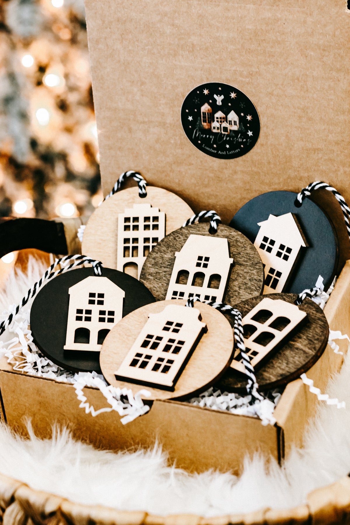 Round house ornaments in kraft gift box, featuring light wood, dark, and teal discs