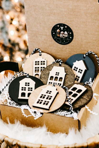 Round house ornaments in kraft gift box, featuring light wood, dark, and teal discs