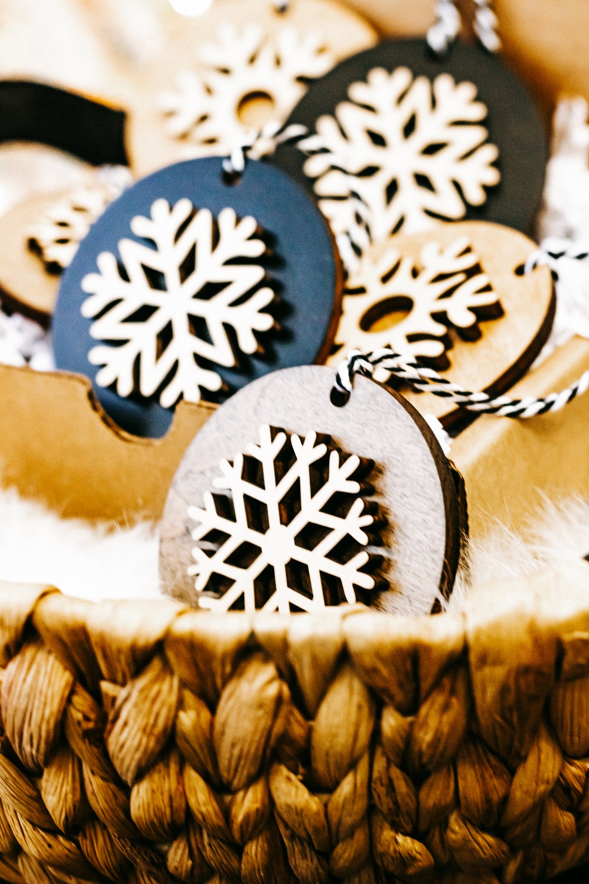 Cluster of layered snowflake ornaments, black and light wood rounds with white snowflakes