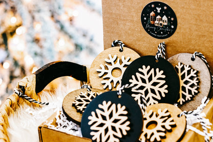 Mixed layered snowflake ornaments: black and light wood discs with white cutout snowflakes