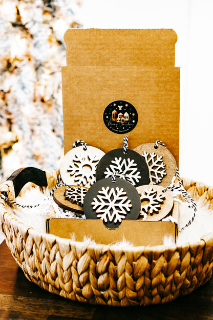Snowflake ornaments on display in woven basket, black and light wood round discs