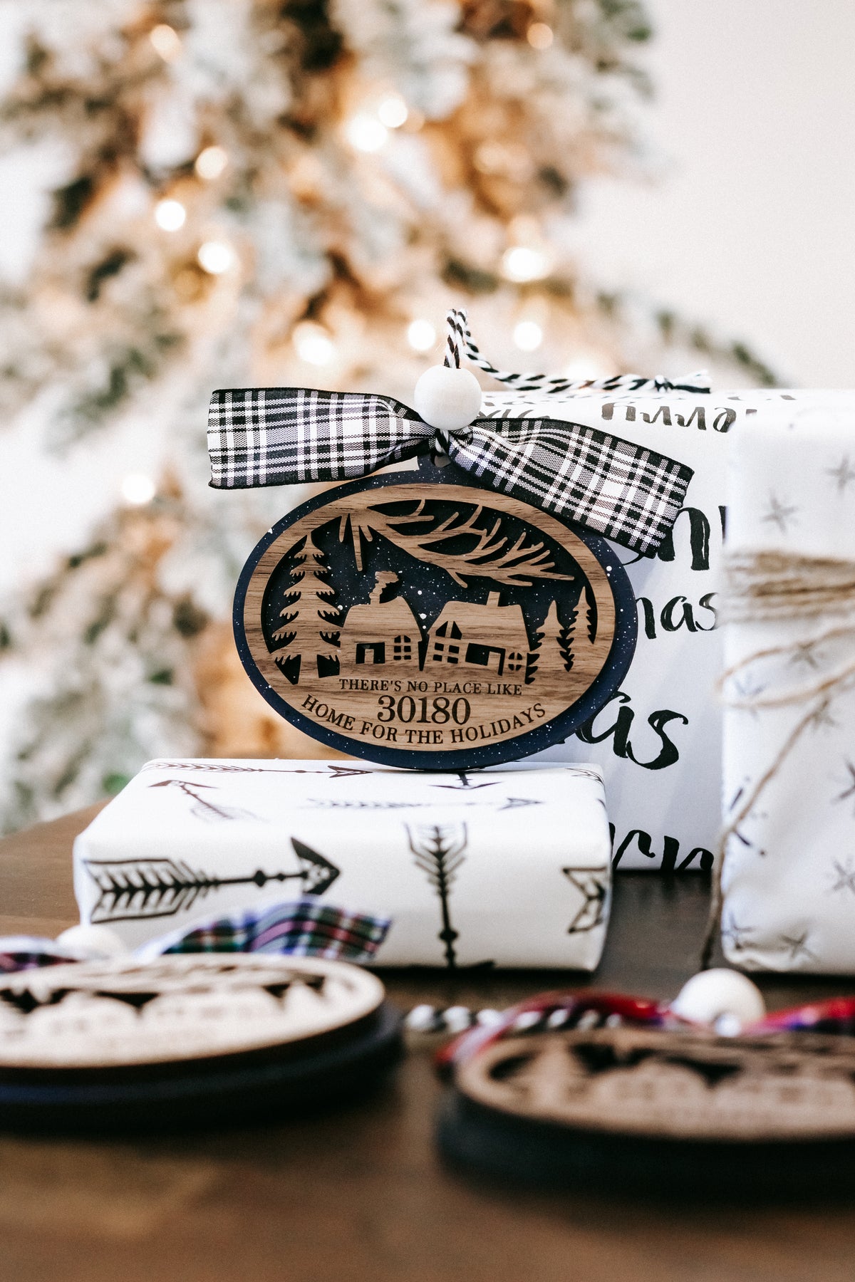 Round wood Christmas ornament with 30180 zip code, house scene, and black plaid bow