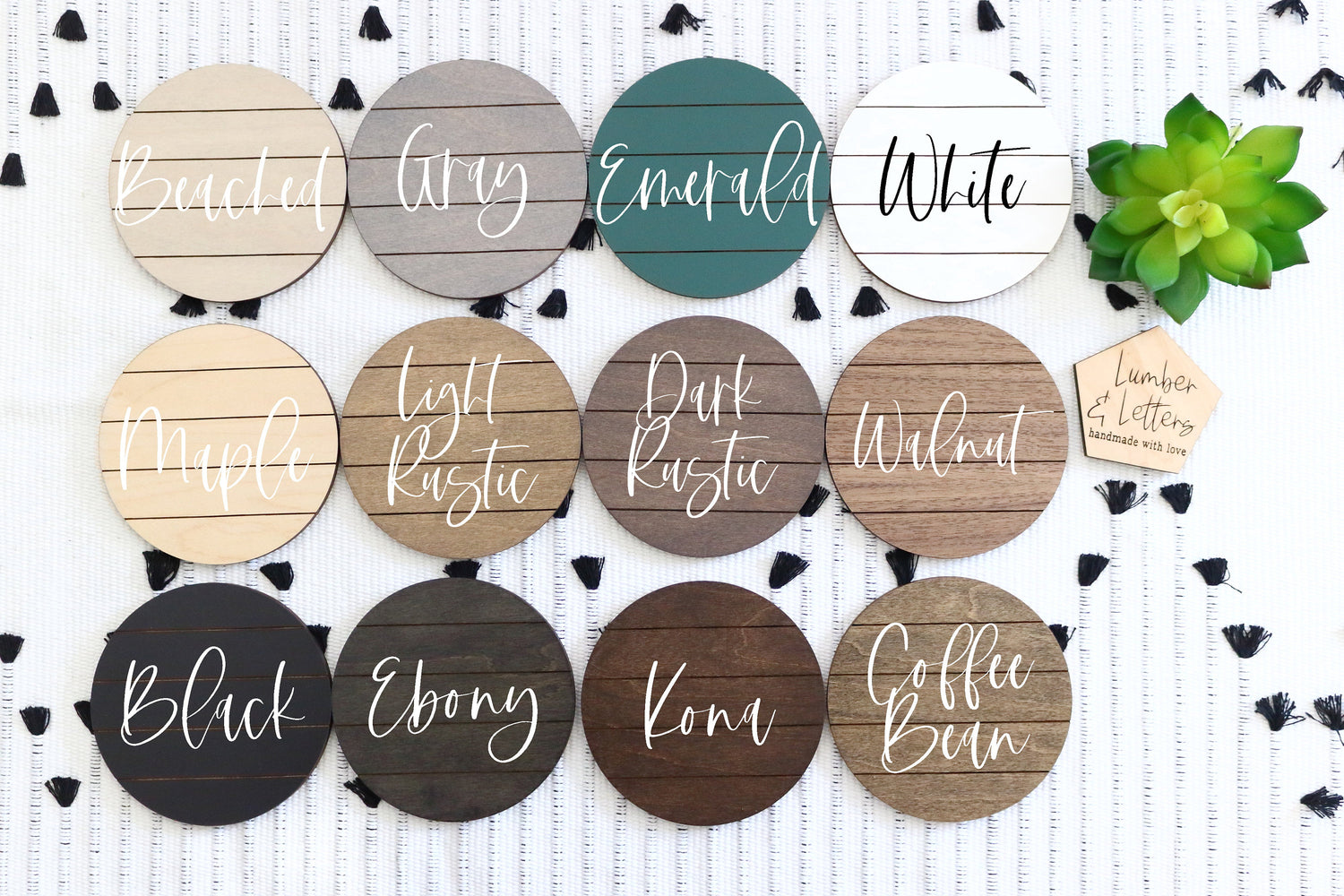 Round finish samples for restroom signs in multiple colors, displayed on a patterned board