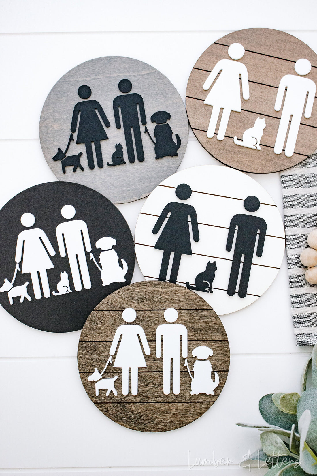 Round restroom sign with pet silhouettes, shown in multiple color circles (gray, tan, black)